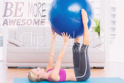 Composite image of cheerful fit blonde holding exercise ball bet