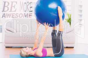 Composite image of cheerful fit blonde holding exercise ball bet