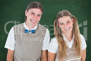 Composite image of smiling geeky hipsters looking at camera
