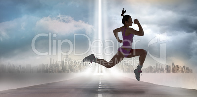 Composite image of fit brunette running and jumping Composite image of fit brunette running and jumping