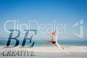 Composite image of fit woman jumping gracefully on the beach wit