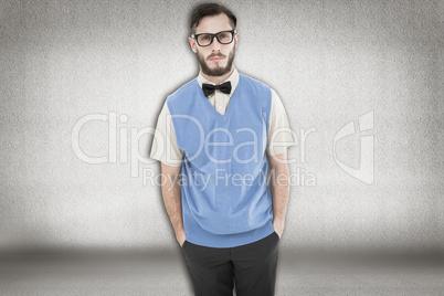 Composite image of geeky hipster looking at camera