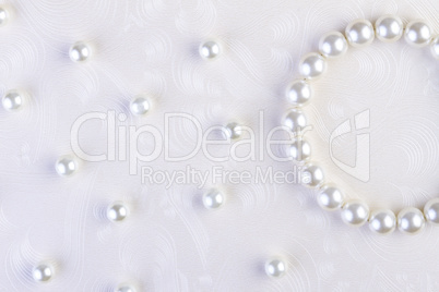 White pearls necklace on white paper