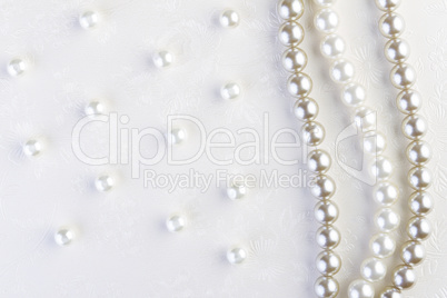 White pearls necklace on white paper