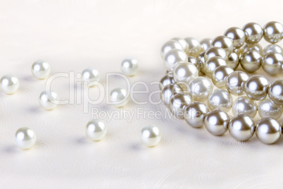 Silver and White pearls necklace on white paper