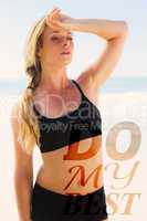 Composite image of fit blonde wiping her forehead on the beach
