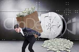 Composite image of businessman carrying bag of dollars