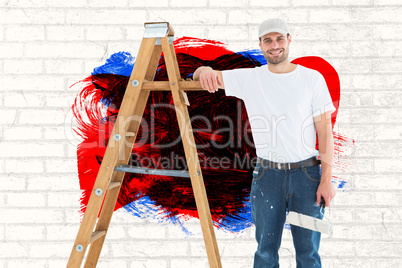 Composite image of happy man with paint roller standing by ladder