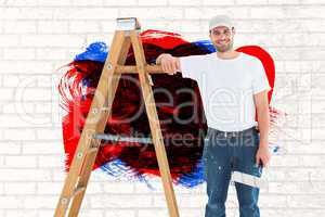 Composite image of happy man with paint roller standing by ladder