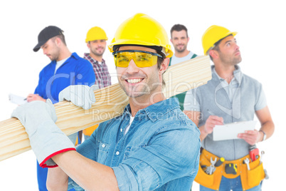 Composite image of carpenter wearing hardhat and glasses while c