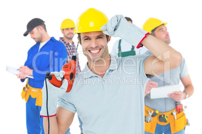 Composite image of handsome architect holding drill machine