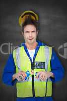 Composite image of electrician getting a shock while holding cab