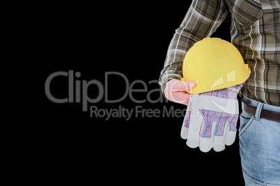 Composite image of manual worker holding helmet and gloves