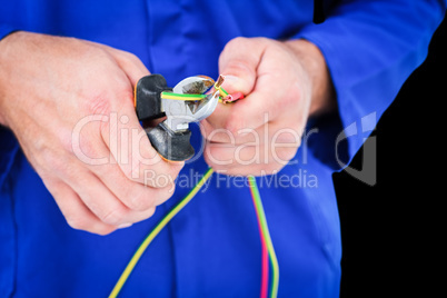 Composite image of electrician cutting wire with pliers