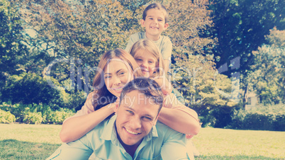 Happy family members lying on each other