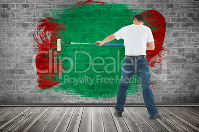 Composite image of man using paint roller on white background