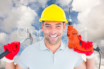 Composite image of happy repairman holding hammer and drill mach