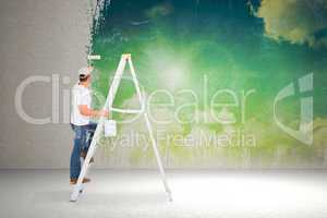 Composite image of handyman climbing ladder while using paint ro