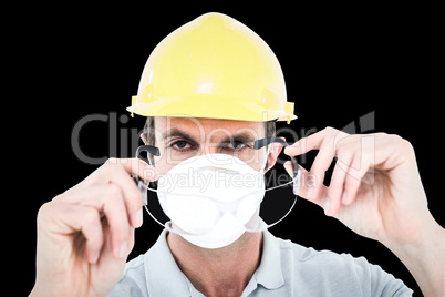 Composite image of worker wearing protective glasses over white