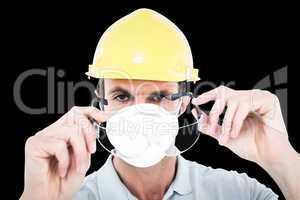 Composite image of worker wearing protective glasses over white
