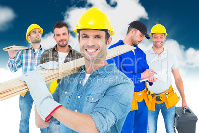 Composite image of happy carpenter carrying wooden planks