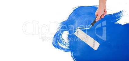 Composite image of handyman holding paint roller