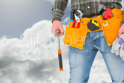 Composite image of manual worker holding gloves and hammer