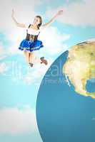 Composite image of pretty oktoberfest girl smiling and jumping
