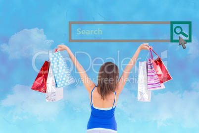 Composite image of rear view of a brunette woman raising shoppin