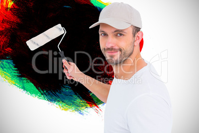 Composite image of handyman holding paint roller