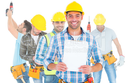 Composite image of portrait of smiling manual worker holding cli