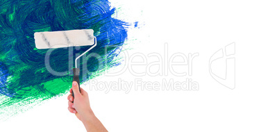 Composite image of handyman holding paint roller