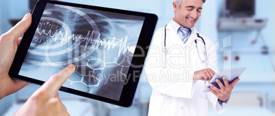 Composite image of man using tablet pc