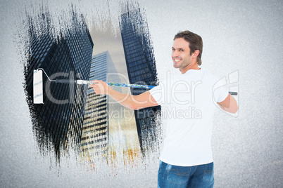 Composite image of happy man using paint roller