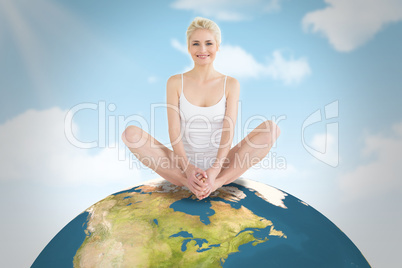 Composite image of toned young woman doing the butterfly stretch