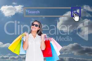 Composite image of pretty brunette with shopping bags