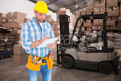 Composite image of manual worker writing on clipboard