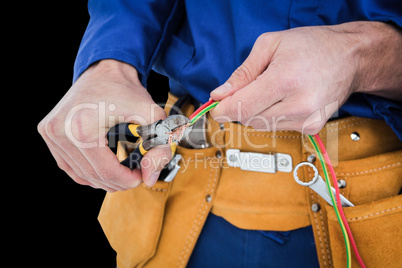 Composite image of electrician cutting wires Composite image of electrician cutting wires