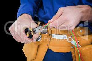 Composite image of electrician cutting wires