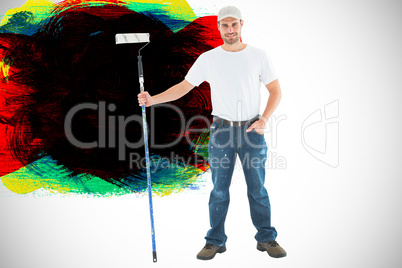 Composite image of confident man holding paint roller on white b