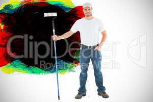 Composite image of confident man holding paint roller on white b