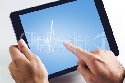 Composite image of man using tablet pc