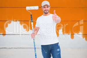 Composite image of handyman holding paint roller