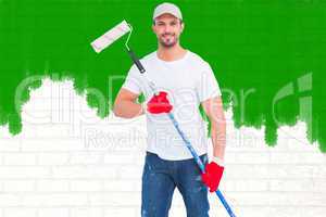 Composite image of handyman holding paint roller