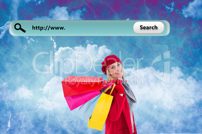 Composite image of blonde in winter clothes holding shopping bag