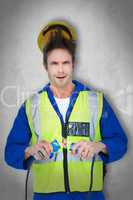 Composite image of electrician getting a shock while holding cab