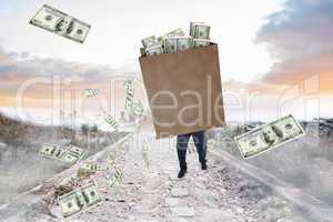 Composite image of businessman carrying bag of dollars