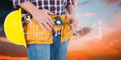 Composite image of handyman with tool belt and handyman