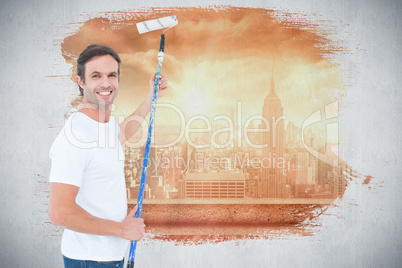 Composite image of happy man using paint roller