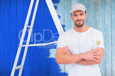 Composite image of handyman with paintbrush and ladder